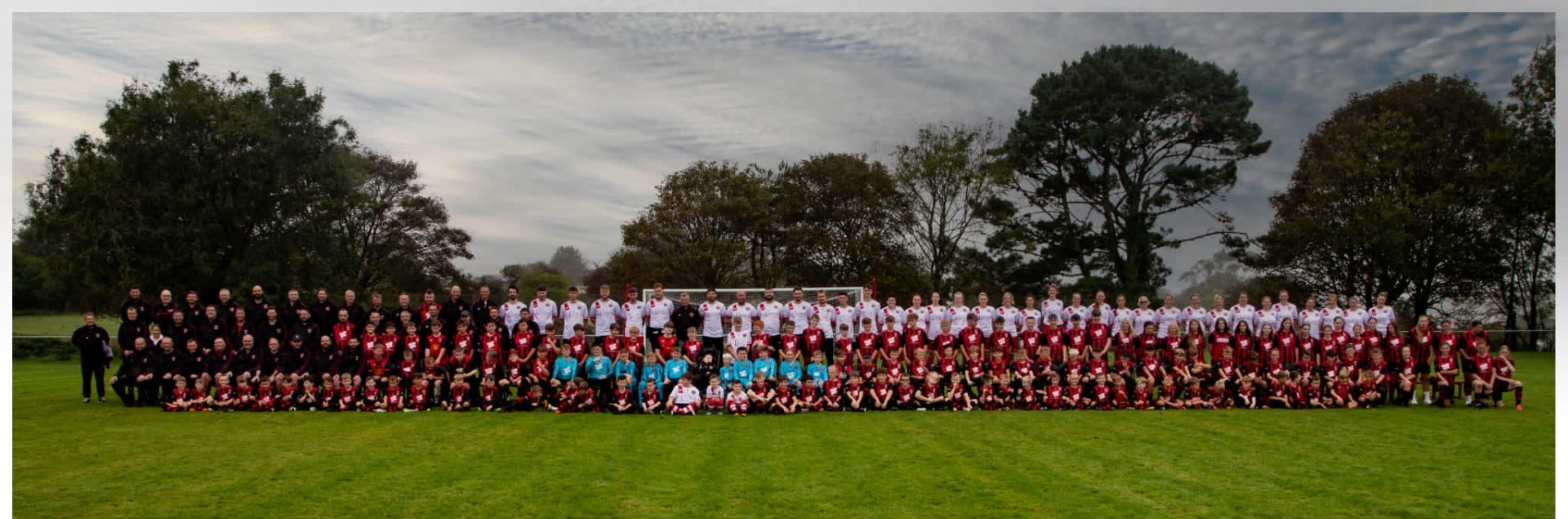 Every Redruth United team lined up together across the pitch for the 2023 whole club photograph